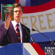 Christian Coalition president Ralph Reed holds a textbook he claims is being used to teach physics in schools.